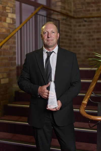 Charlton posing with his award. 