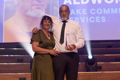 Image of Supreme Winner onstage with award.