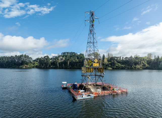 Image of a transmission tower on a lake