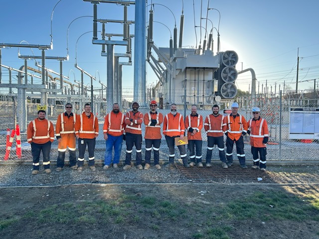 Crew in front of interconnecting transformer at Redclyffe substation